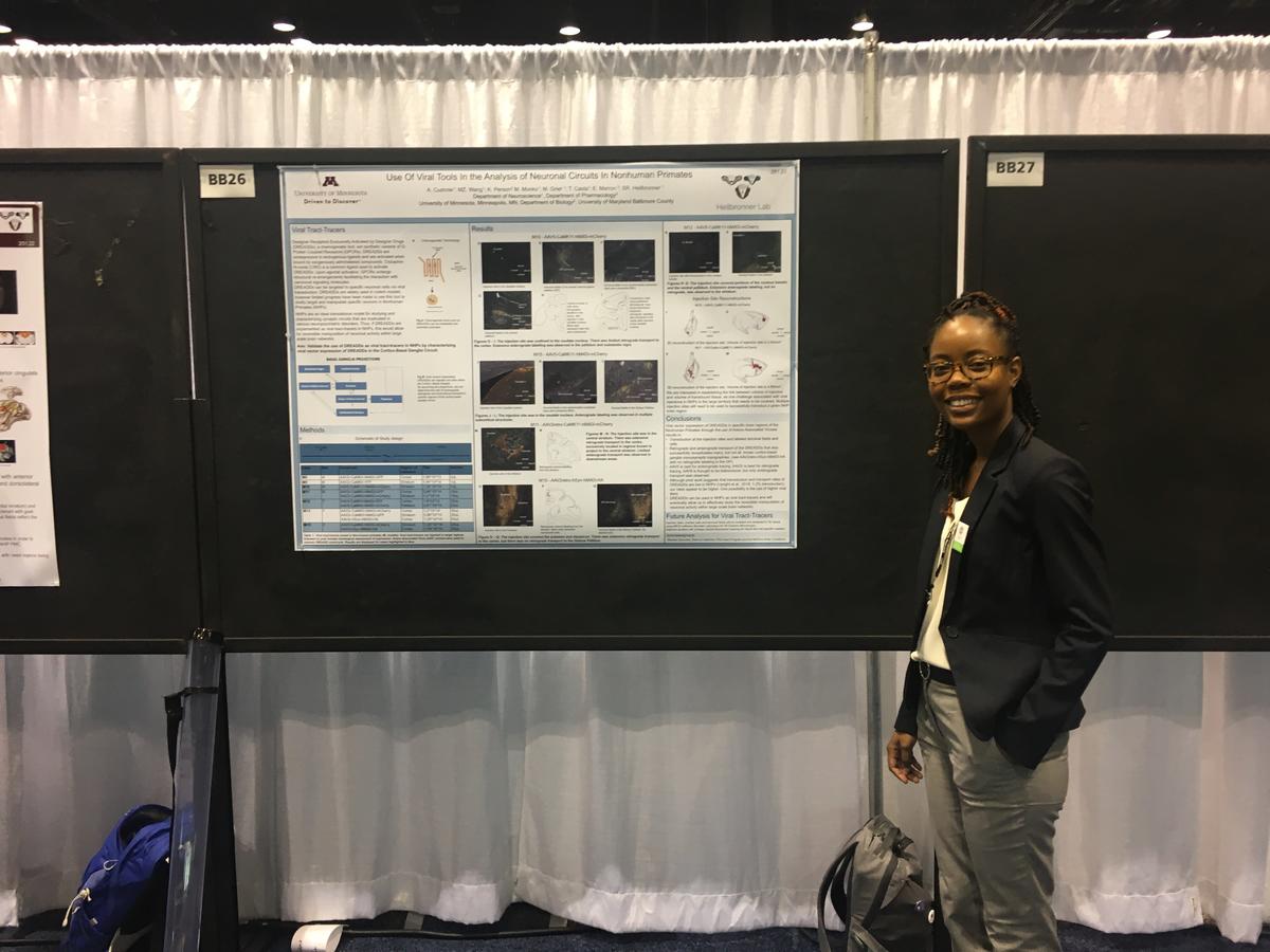 Adriana Cushnie smiles at the camera in front of her poster "Use of Viral Tools in the Analysis of Neuronal Circuits in Nonhuman Primates"